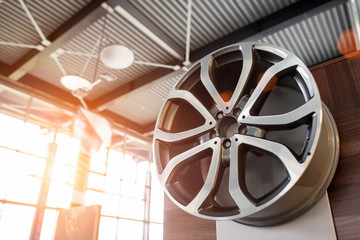 Modern alloy car drive on a background of sunny sunset. The concept of buying stylish wheels on a...