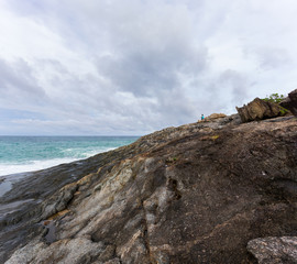 Fototapeta na wymiar Rocky coast of the Andaman Sea, rocks and blue water