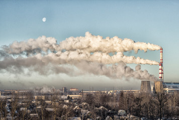 Strong smoke from the chimneys on the background of blue sky and moon. The concept of environmental pollution and global warming, cogeneration plant