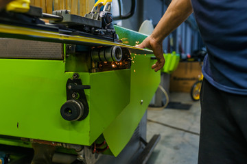 Ski repair shop worker adjust the bindings