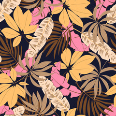 Original seamless tropical pattern with bright plants and leaves on a dark blue background. Beautiful seamless vector floral pattern. Exotic jungle wallpaper. Hawaiian style.