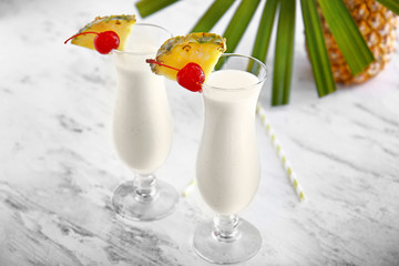 Glasses of tasty Pina Colada cocktail on table