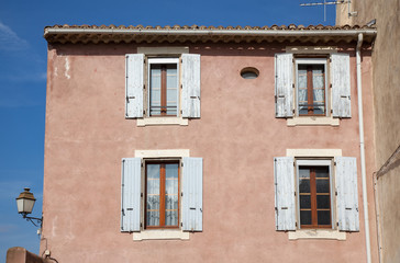 Fototapeta na wymiar Pink house facade in the old town area of Beziers, France.