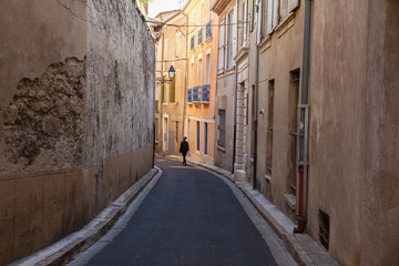 Narrow street in Beziers old town, France.