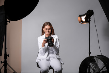 Beautiful female photographer in studio