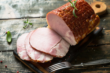 A large piece of smoked ham. Meat on the table