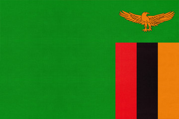 Republic of Zambia national fabric flag, textile background. Symbol of international world African country. - obrazy, fototapety, plakaty