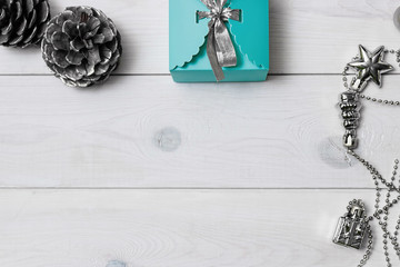 Christmas gift blue on a white wooden background. New Year present.