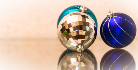 The composition of blue and silver Christmas balls. New Year's toys on a glass surface.