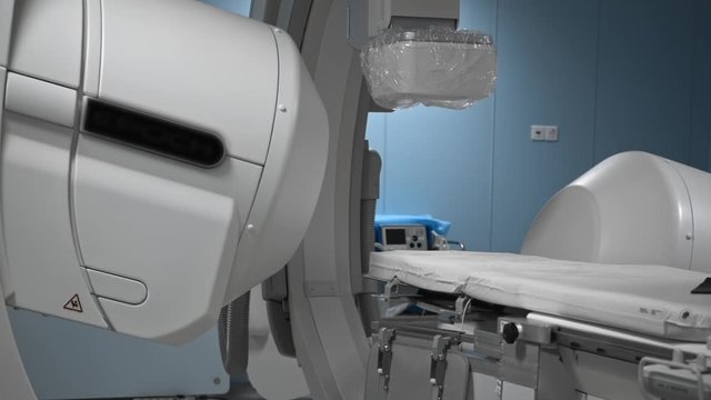 Modern medical robot for human diagnostic in operating room. Robotic medicine. Empty sterile operating room or lab with monitors and moving parts of futuristic device close-up