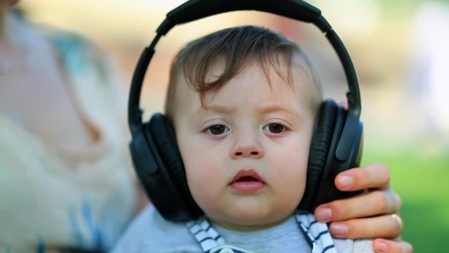 Baby Child Listening To Music With Headphones For The First Time