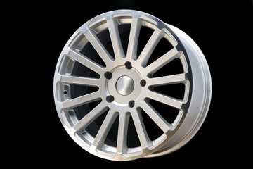 new vehicle rims made from aluminum alloy, multi-spoke silver wheel, close-up on a black background