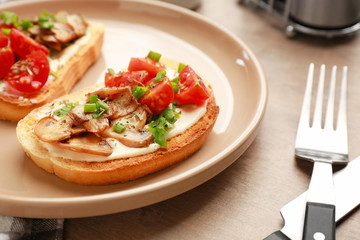 Plate with tasty sandwiches on table, closeup