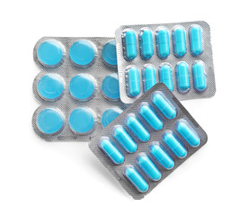 Blister packs with different pills on white background