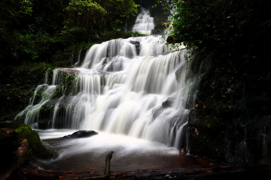 Mandang waterfall in Thailand,With pink flowers near the waterfall.