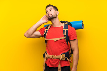 Young hiker man listening something