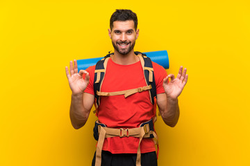 Young hiker man showing an ok sign with fingers