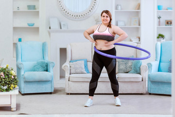 The model is a fat woman, trying to lose weight at home and doing exercises with halajup © ribalka yuli