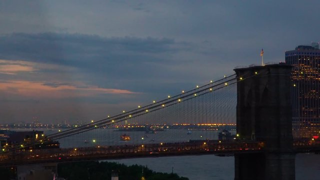Brooklyn Bridge at dusk, beautiful moving shot of New York City skyline panorama viewed from the Manhattan Bridge