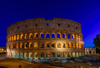 Fototapeta na wymiar Night view of Colosseum in Rome, Italy. Architecture and landmark of Rome. Postcard of Rome.