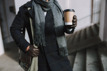 Adult man in warm clothes drinking coffee