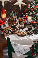 Christmas table with traditional pastries in rustic style interior