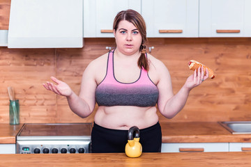 sport with unhealthy food. combination of active life with fast food. close up photo. fat woman...