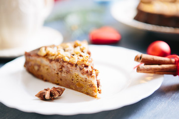 Nuts and honey cake, selective focus Gluten free christmas nut cake on a gray table with christmas decorations