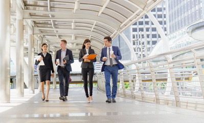 Group of businessman and businesswoman walking and meeting together outdoor