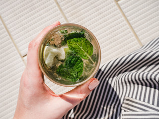 Beautiful glass with refreshing mojito and ice cubes