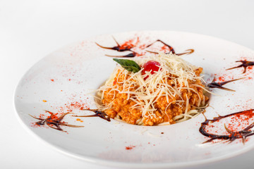 Spaghetti with tomato and minced meat with cheese on a white background