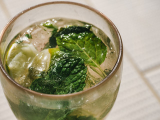Beautiful glass with refreshing mojito and ice cubes