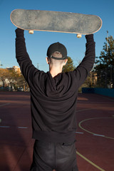 Cool skateboarder outdoors - guy jumping with his skate 