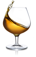 splash of cognac in a snifter isolated on white background