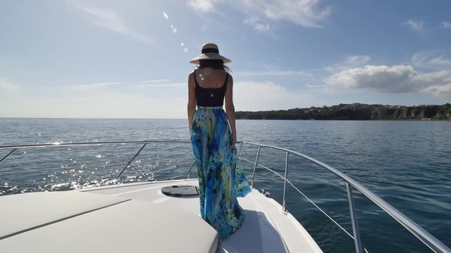 woman walk on luxury motor yacht in procida island, italy