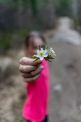 Girl holding up some flowers