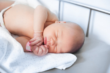 pretty newborn baby sleeps in a crib