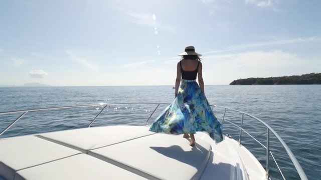 woman walk on luxury motor yacht in procida island, italy