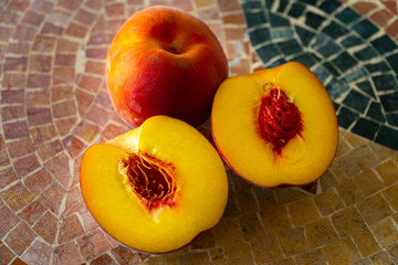 Close up of fresh nectarines on a stone table