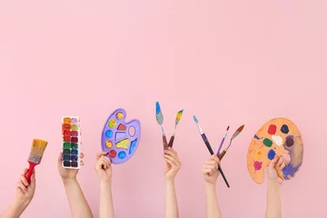 Foto op Plexiglas Female hands with painter's supplies on color background © Pixel-Shot