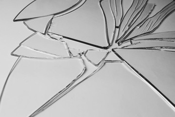 Broken glass pile pieces of texture and background isolated on white, cracked window effect. Emergency condition.