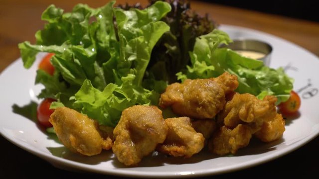 fried karake chicken with salad on plate