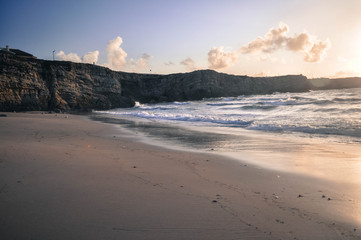 Fototapeta na wymiar on the shore of Atlantic ocean. Sunset on the beach. Portugal.