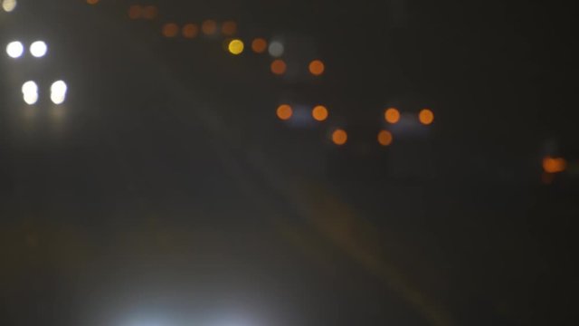 Defocused Night City Traffic Lights. Color Blurred bokeh of moving transport and typical city noise.