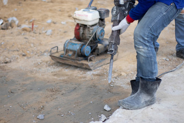 Workers are using the tools to extract the excess cement to the pattern. With white cloth gloves Blue shirt, jeans, small side plate in construction area