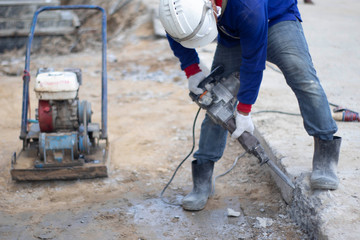 Workers are using the tools to extract the excess cement to the pattern. With white cloth gloves Blue shirt, jeans, small side plate in construction area