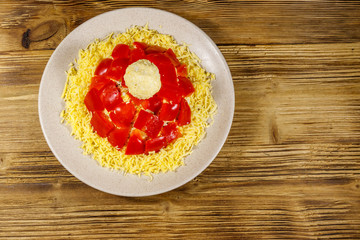 Christmas salad Hat of Santa Claus on a wooden table. Top view