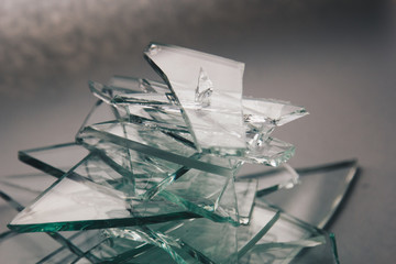 Broken glass background for your images isolated on white. Many large glass fragments scattering...