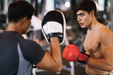 Coach thai are training men boxer with boxing glove  at the gym, fitness, boxing camp.