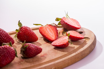 cut strawberries on a cutting board